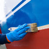 TotalBoat White Knight Fiberglass Stain Remover being brushed on a boat