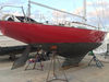 TotalBoat Wet Edge Topside Paint Fire Red on a sailboat hull